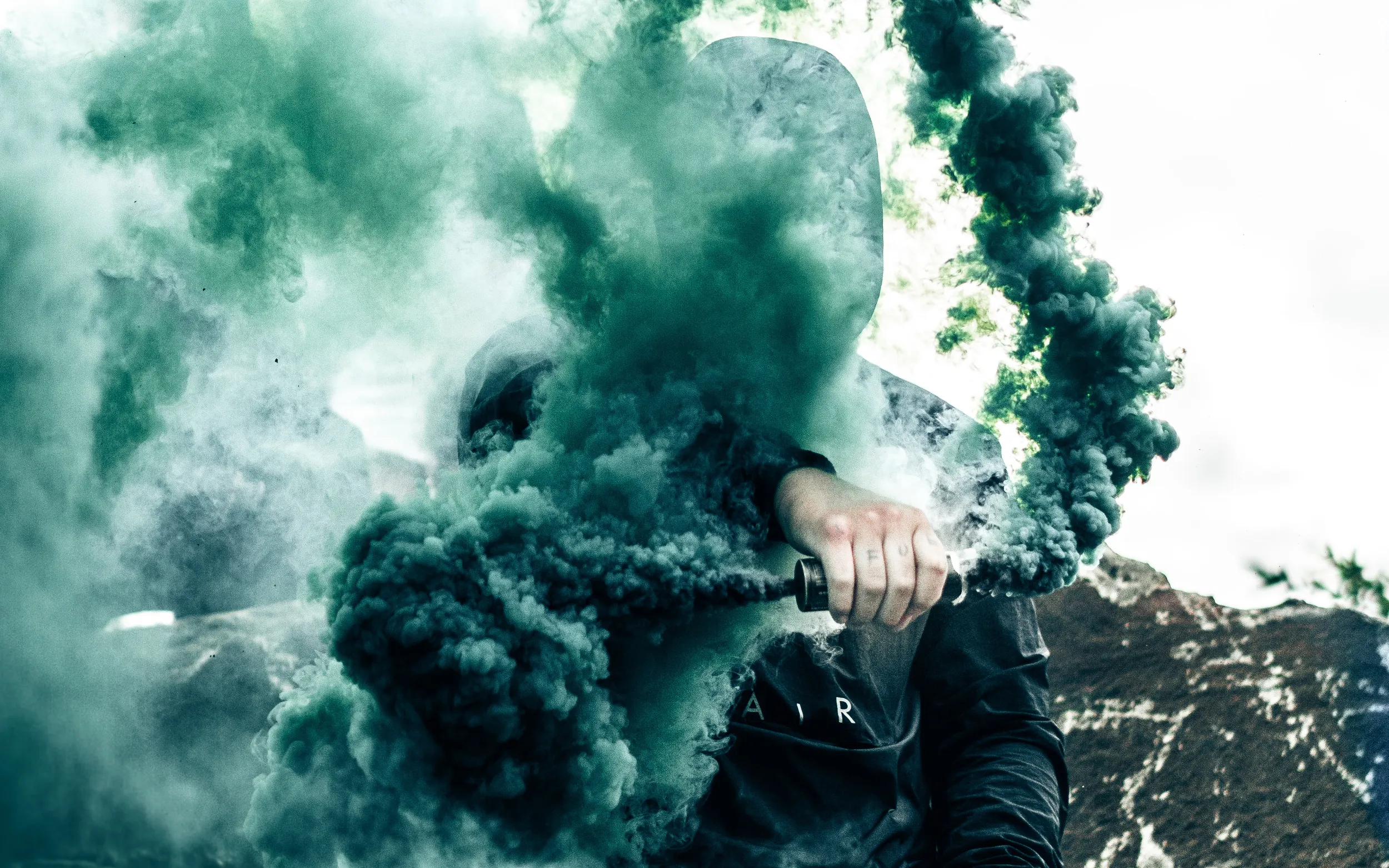 Techwear guy using a bengalo with green smoke