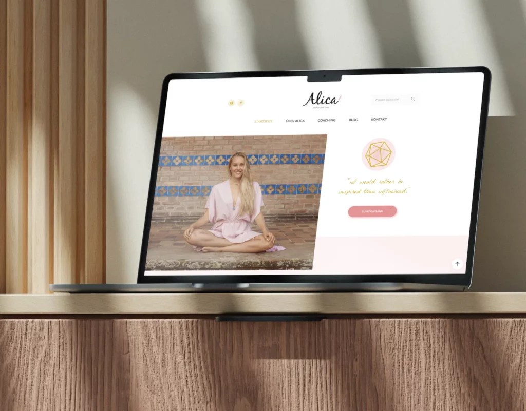 Laptop displaying a website with the header "Alica," showcasing a woman named Alica Preetz sitting cross-legged in a pink outfit, symbolizing a coaching theme. The website design features a quote, "I would rather be inspired than influenced," and links to coaching, blog, and contact pages.