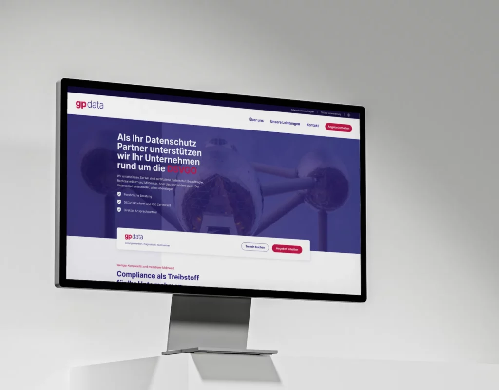A monitor displaying the gpdata website design focused on GDPR (DSGVO) compliance services. The screen highlights services such as personal consultation, GDPR compliance, and ISO certification. The design features a blue background with options to book an appointment or get an offer.