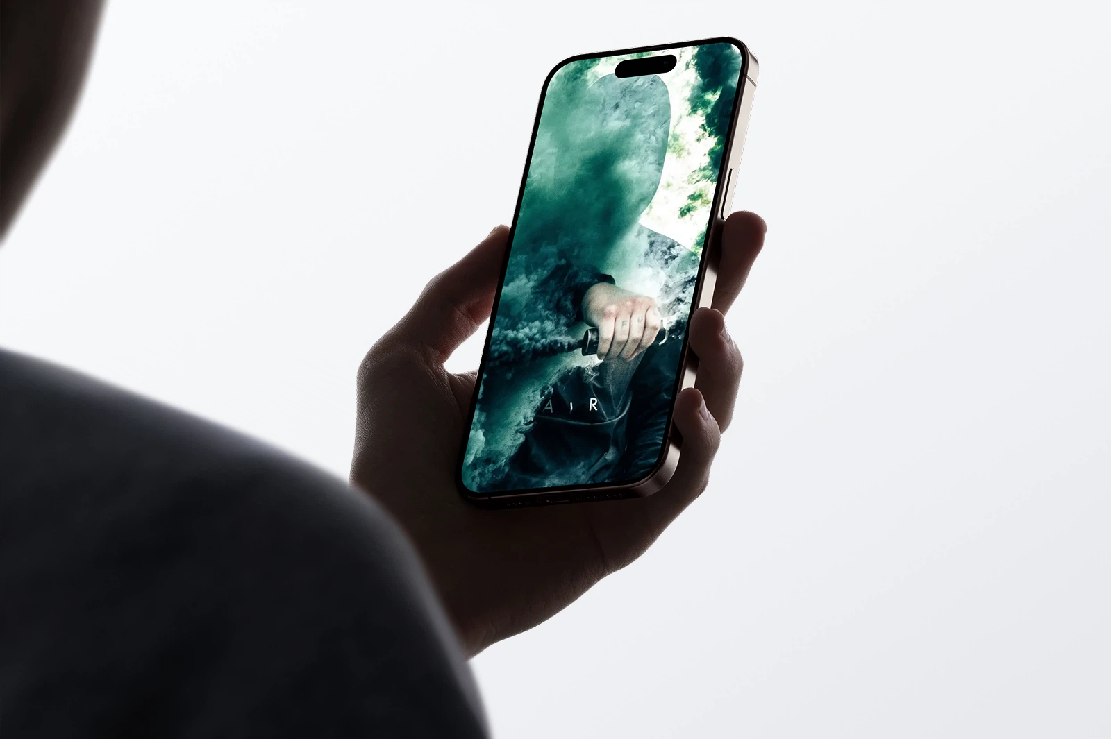 A person holding a smartphone displaying a techwear-themed image. The image features a faceless figure with smoke effects, wearing a techwear jacket, creating a mysterious and futuristic vibe.